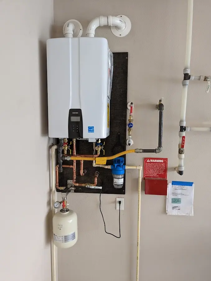 Professional plumber installing copper piping in a Hubbard home